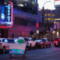A pedicab biking down N 7th Street in front of First Avenue on a busy Thursday night in downtown Minneapolis.