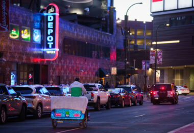 A pedicab biking down N 7th Street in front of First Avenue on a busy Thursday night in downtown Minneapolis.