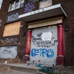 A sign on the front of the "Dundry House" in Minneapolis. It reads "this building will be demolished May 20". The building was destroyed by fire in April 2024. The building had been vacant.