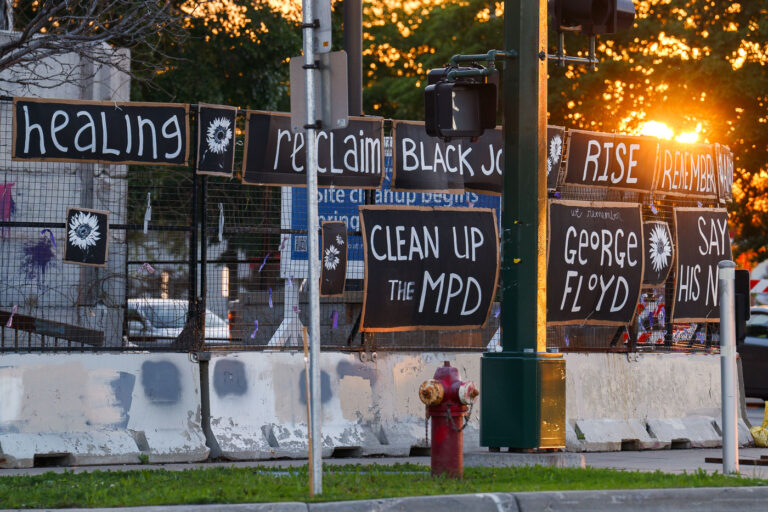 Minneapolis Police Station 4 years later 2 Signs hang on the fencing around the Minneapolis Police 3rd Precinct police station. The station burned 4 years ago on this day.