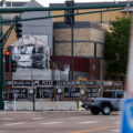 Signs hang on the Minneapolis police 3rd precinct police station on the 4 year anniversary of protesters burning it.