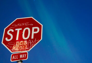 A Stop Sign in South Minneapolis with the Northern Lights visible behind it.