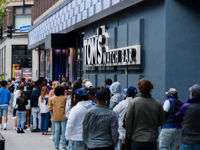 Line Forms on Hennepin Avenue for Tom's Watch Bar During Playoffs
