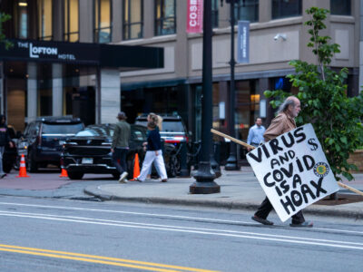 Minneapolis Man Carries Anti-COVID Sign Downtown