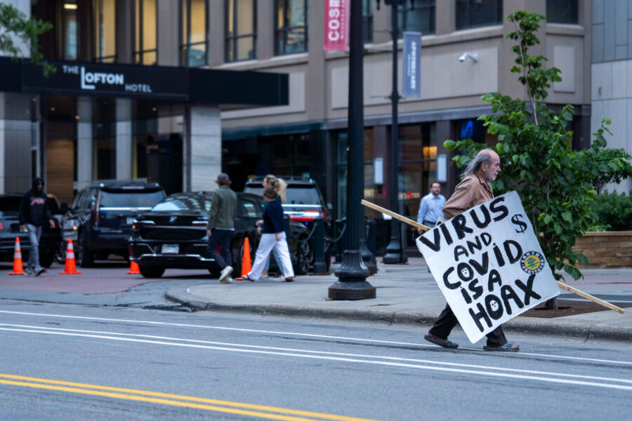 Minneapolis Man Carries Anti-COVID Sign Downtown
