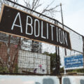 Signs hang on the former Minneapolis Police 3rd precinct police station on June 19th, 2024. The station has sat vacant since it was burned by protesters following the May 25th, 2020 murder of George Floyd.