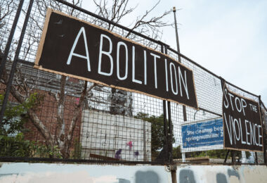 Signs hang on the former Minneapolis Police 3rd precinct police station on June 19th, 2024. The station has sat vacant since it was burned by protesters following the May 25th, 2020 murder of George Floyd.