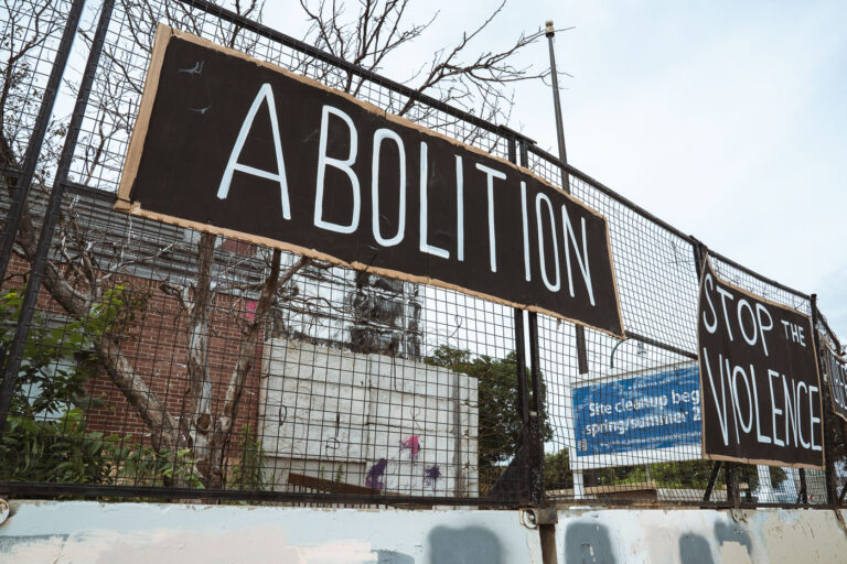 Abolition Stop The Violence 3 Signs hang on the former Minneapolis Police 3rd precinct police station on June 19th, 2024. The station has sat vacant since it was burned by protesters following the May 25th, 2020 murder of George Floyd.
