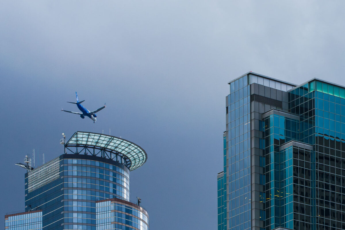 An Alaskan Airlines plane flies over Downtown Minneaopolis.