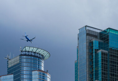 An Alaskan Airlines plane flies over Downtown Minneaopolis.