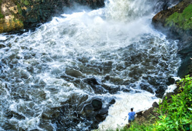 A man fishes at the bottom of Minnehaha Falls in Minneapolis.