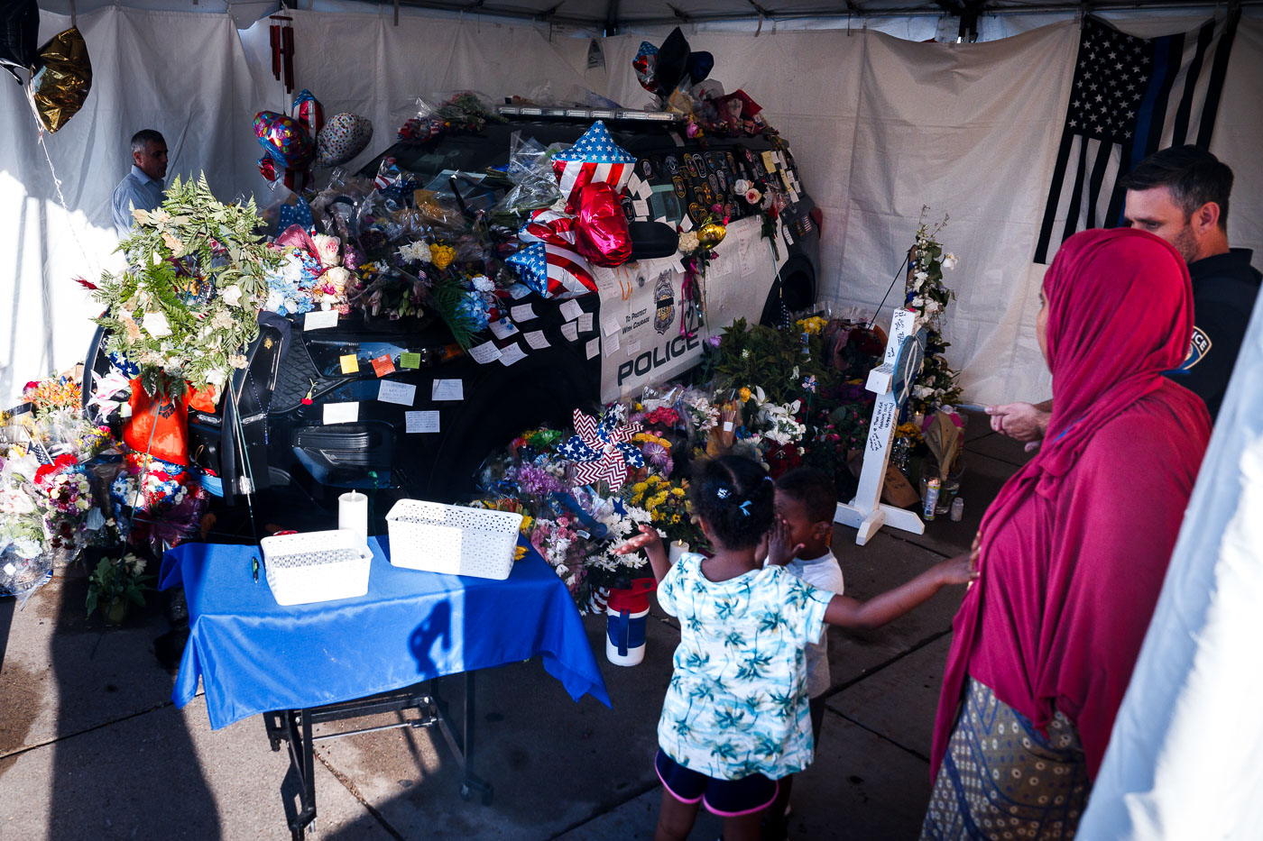 People looking at memorial for Jamal Mitchell