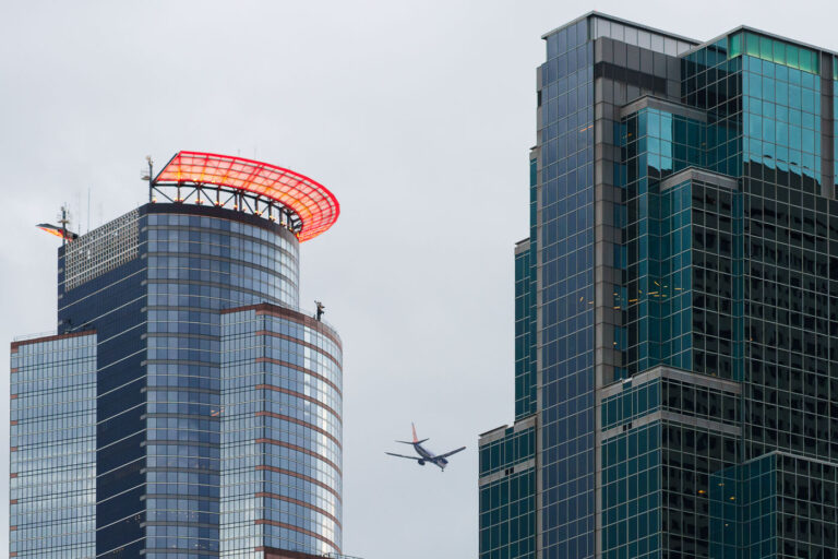 Airplane flies through Downtown Minneapolis 1 A Sun Country Airlines plane flies above downtown Minneapolis.