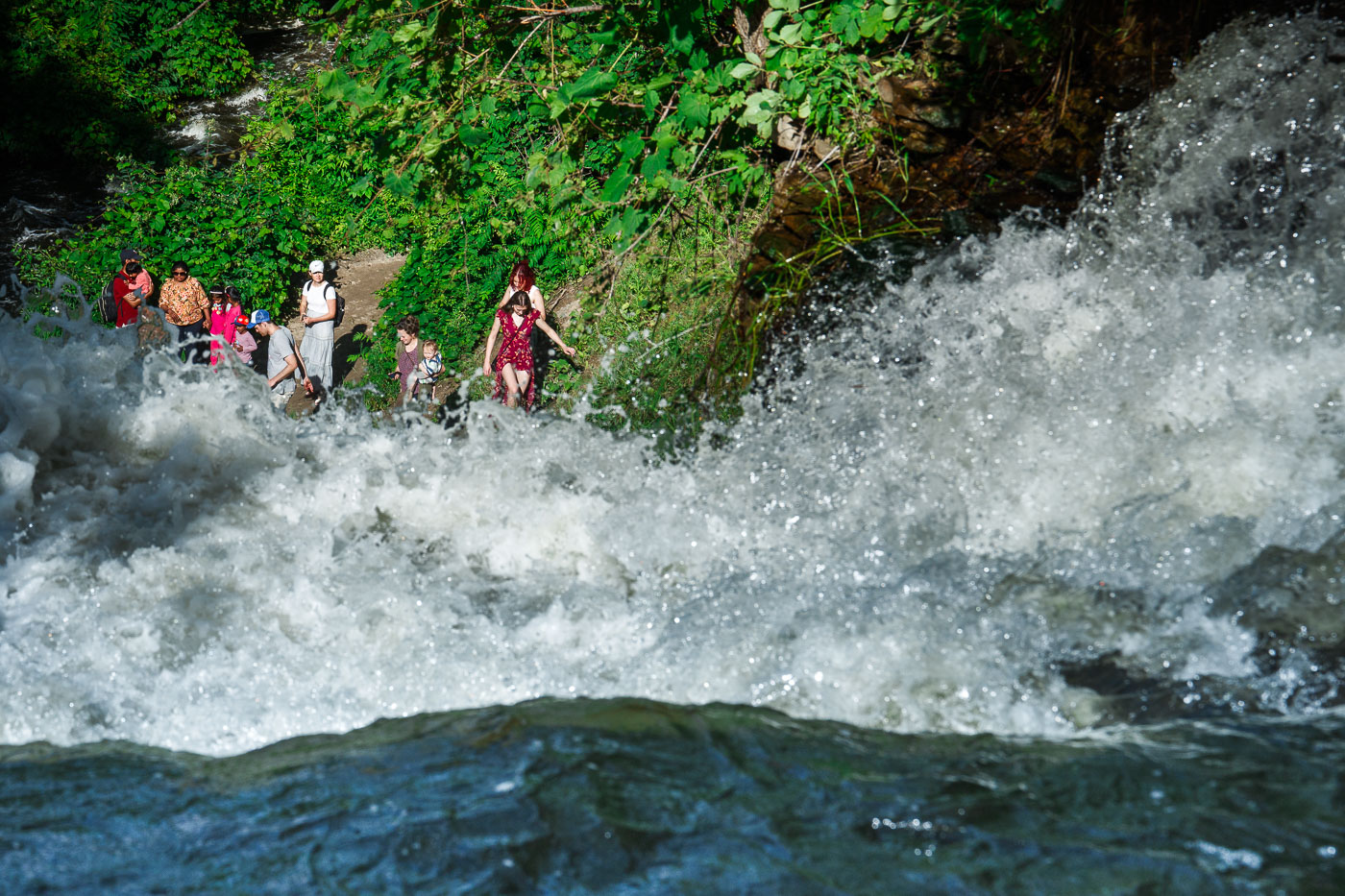 Visitors at the base of Minnehaha Falls June 2024