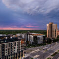 Lake Street and Excelsior Blvd near the western edge of Minneapolis during a June sunset. Waterbury House on the left where rent ranges from $2,495 to $12,995 a month. The apartment building on the triangle lot replaced a long standing BP gas station.