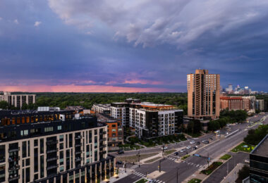 Lake Street and Excelsior Blvd near the western edge of Minneapolis during a June sunset. Waterbury House on the left where rent ranges from $2,495 to $12,995 a month. The apartment building on the triangle lot replaced a long standing BP gas station.