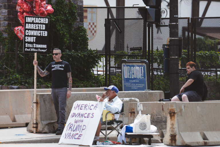 2024 RNC America Advanced with Trump Vance 1 Supporters of Donald Trump hold up signs outside the entrance of the 2024 Republican National Convention,