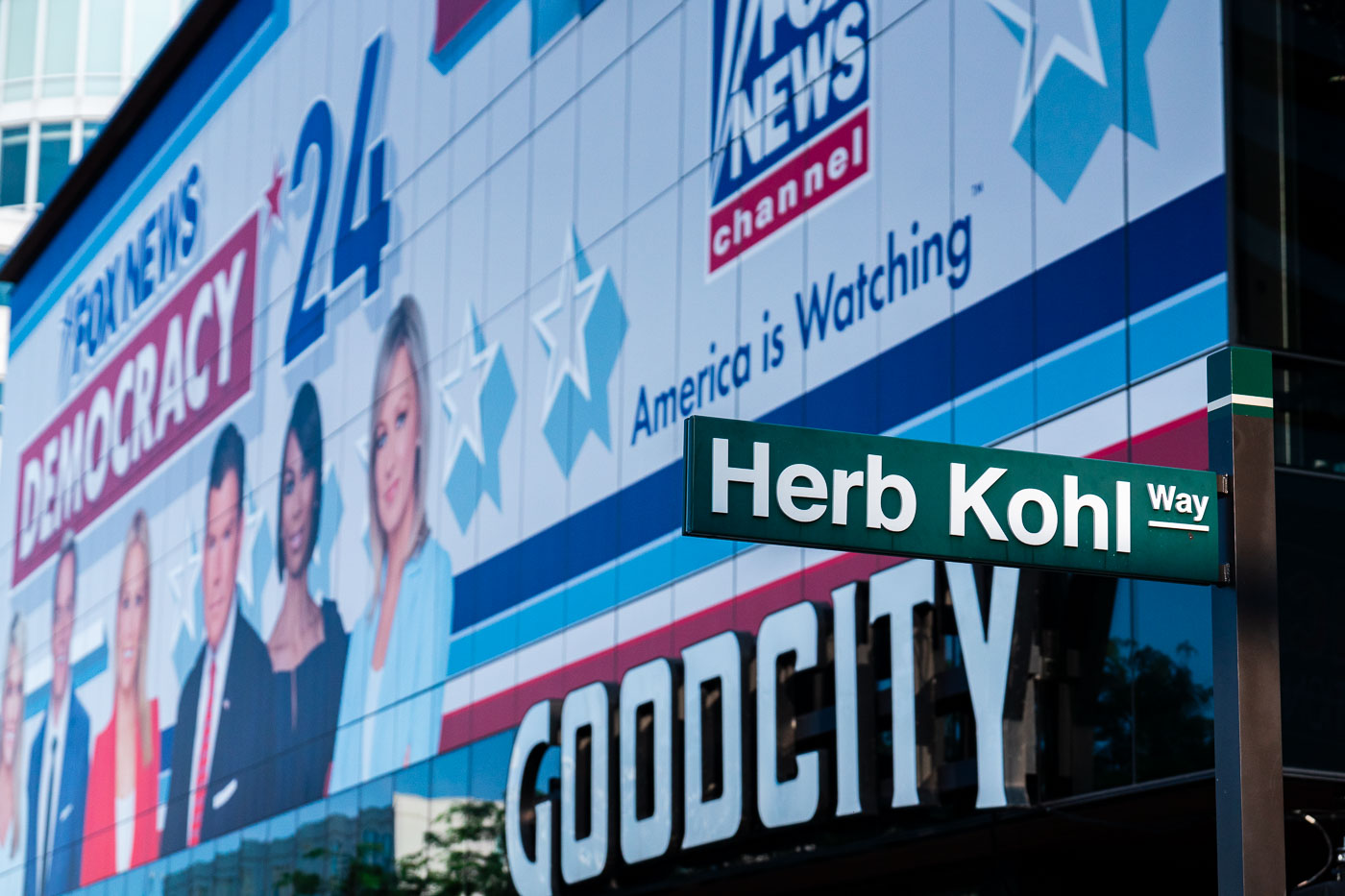 Fox News banner behind a Herb Kohl Way sign outside Fiserv Forum.