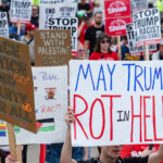 Protester holds up a sign that reads "May Trump Rot in Hell" at a march outside the 2024 Republican National Convention.