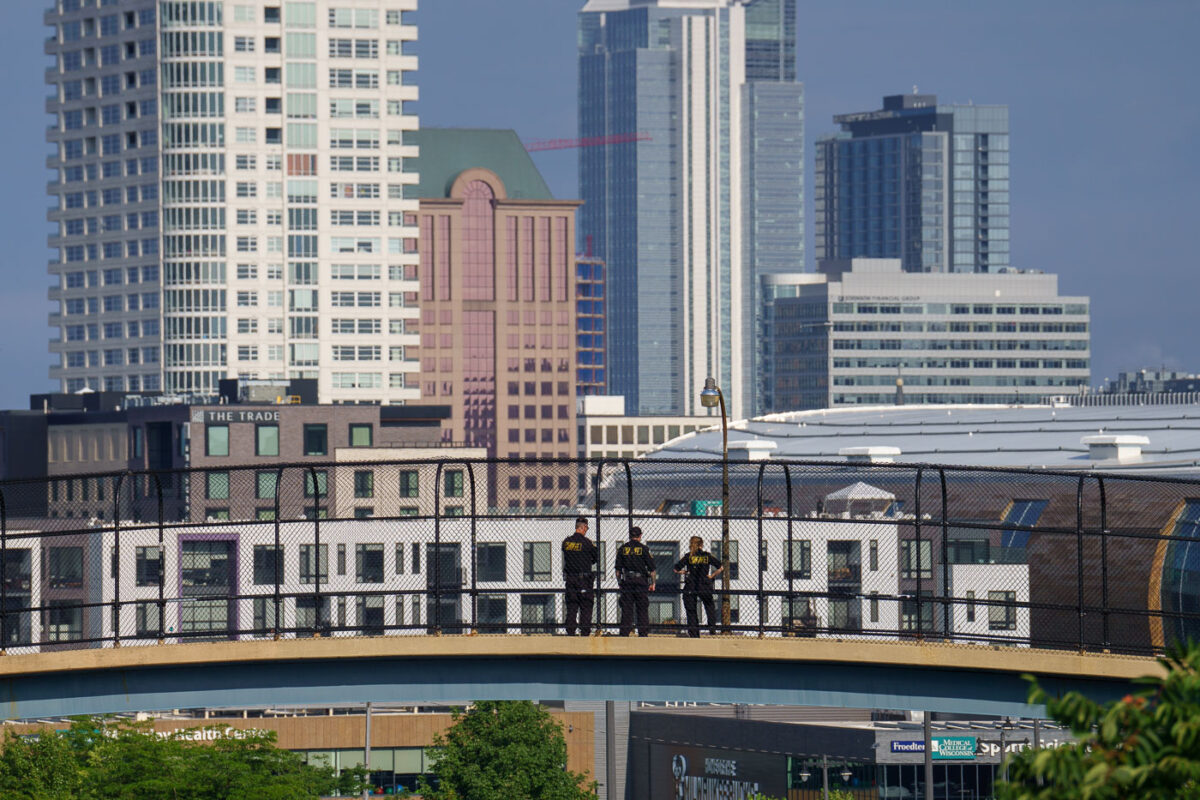 Officers stand on a walkway over the freeway during the Republican National Convention.