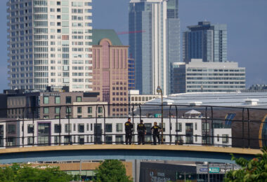 Officers stand on a walkway over the freeway during the Republican National Convention.