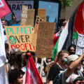 Protesters at the 2024 RNC in Milwaukee. Holding signs that read "Planet over profit", "People over corporations", "Stand with Palestine".