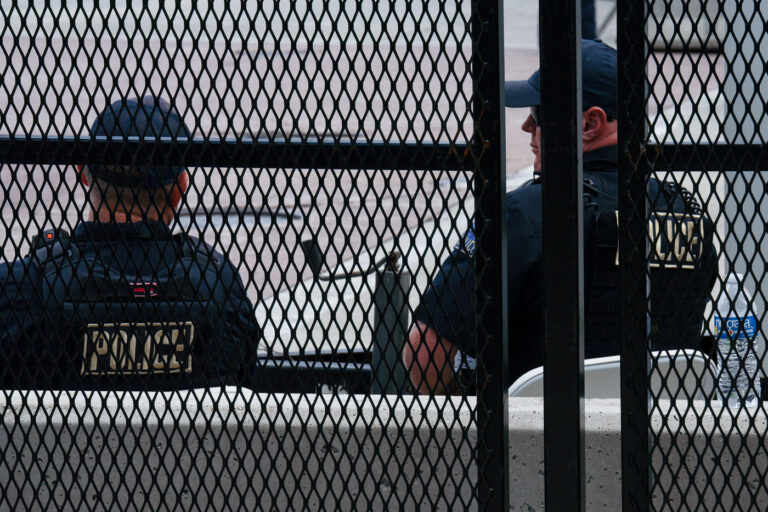 2024 RNC Police behind secure fencing 2 Police officers behind the secure perimeter at the 2024 Republican National Convention in Milwaukee.