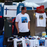 A vendor at the 2024 Republican National Convention selling t-shirts with a photo of Trump following an assassination attempt days prior.