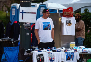 A vendor at the 2024 Republican National Convention selling t-shirts with a photo of Trump following an assassination attempt days prior.