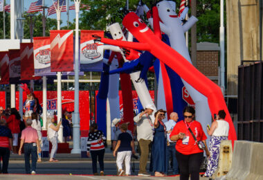 At tonight's RNC welcome party put on by the Milwaukee Host Committee. Photo: A couple wearing Make America Great Again again apparel get a photo taken raising their firsts recreating the now famous image of former President Trump surviving an assassination attempt the day before.