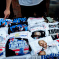 A T-shirt vendor at the Republican National Convention. Pointing to what he says is his best selling shirt, one of after Trump was shot.