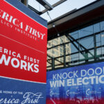 America First Policy Institute and Turning Point Action banners outside the Fiserv Forum in Milwaukee, the site of the 2024 Republican National Convention.
