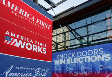 America First Policy Institute and Turning Point Action banners outside the Fiserv Forum in Milwaukee, the site of the 2024 Republican National Convention.