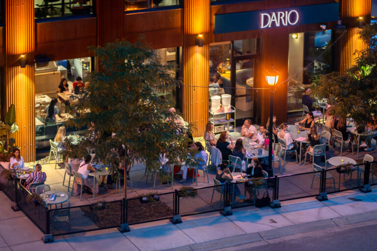 Evening Dining at Dario, North Loop Minneapolis 2 Dario, a modern Italian restaurant in the North Loop of Minneapolis, serves as a popular evening gathering spot for locals and visitors alike. The restaurant opened in 2023, quickly gaining attention for its refined approach to contemporary Italian cuisine and its sleek architectural design featuring warm wood paneling and large glass façades that invite a soft street glow inside.
The patio along Washington Avenue fills during summer evenings, with diners enjoying shared plates and cocktails under the ambient light of the city’s post-industrial district. This corner of the North Loop—once dominated by warehouses—has evolved into one of Minneapolis’s most dynamic culinary destinations, where restaurants like Dario reflect the neighborhood’s transformation into a hub of design, dining, and nightlife.