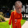 A man dressed as Donald Trump in jail uniform with handcuffs outside the Republican National Convention.