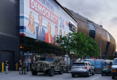 Security fencing and vehicles at an entrance to the hard security zone at Fiserv Forum during the 2024 Republican National Convention.