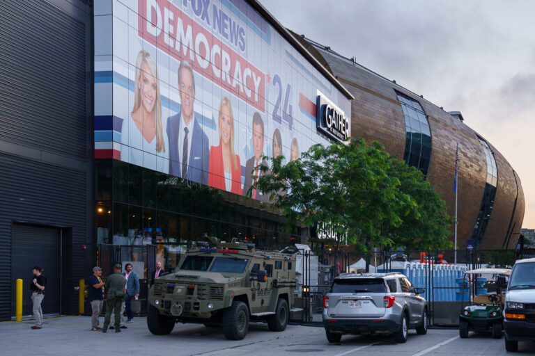 Fiserv Forum security at 2024 RNC 3 Security fencing and vehicles at an entrance to the hard security zone at Fiserv Forum during the 2024 Republican National Convention.