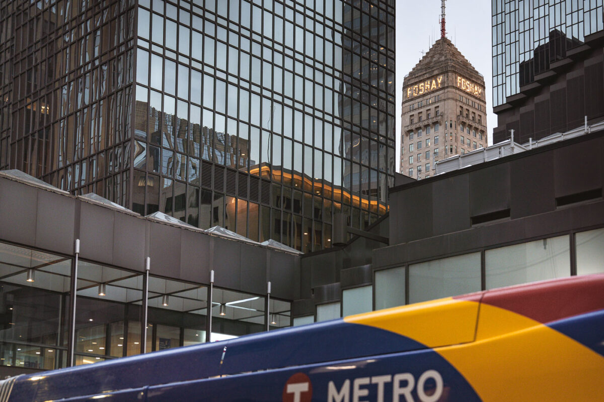 The Foshay Tower and IDS Center in Downtown Minneapolis with a Metro Transit bus passing.