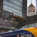The Foshay Tower and IDS Center in Downtown Minneapolis with a Metro Transit bus passing.