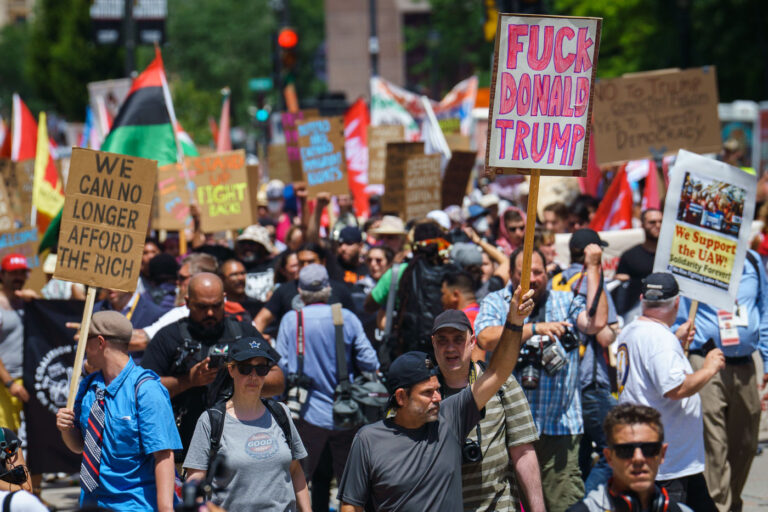 Fuck Donald Trump RNC Protest Sign 4 A man holds up a "Fuck Donald Trump" protest sign at a march outside the 2024 Republican National Convention.