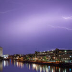 Lightning hits Fiserv Forum in Milwaukee tonight as former President Trump makes an appearance at Day 1 of the 2024 Republican National Convention. With a bandage on his ear following an assassination attempt 2 days ago, he appeared for the first time with chosen VP, J.D. Vance.