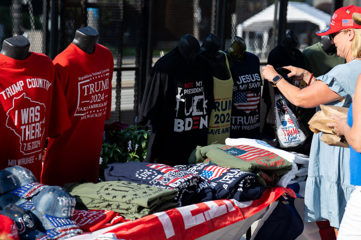A woman looks at Trump merchandise outside the 2024 Republican National Convention.