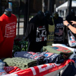 A woman looks at Trump merchandise outside the 2024 Republican National Convention.