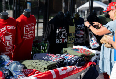 A woman looks at Trump merchandise outside the 2024 Republican National Convention.