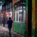 A man walking on the sidewalk down Lake Street in South Minneapolis.