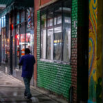 A man walking on the sidewalk down Lake Street in South Minneapolis.