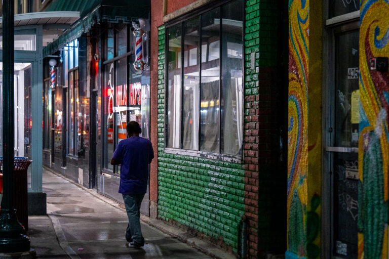 Man walks down Lake Street in Minneapolis 2 A man walking on the sidewalk down Lake Street in South Minneapolis.