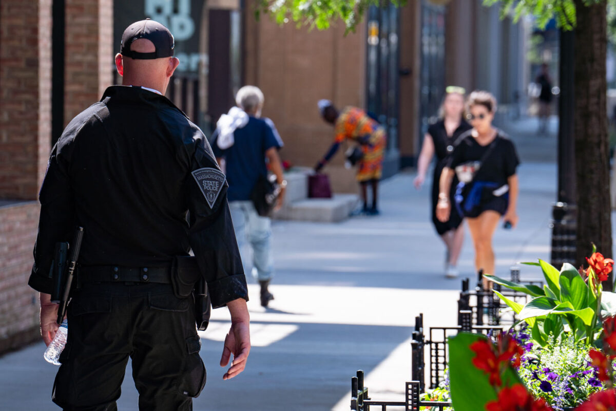 An officer with the Massachusetts State Police walks down the sidewalk in Milwaukee during the 2024 Republican National Convention.