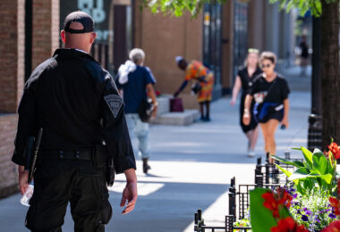 An officer with the Massachusetts State Police walks down the sidewalk in Milwaukee during the 2024 Republican National Convention.