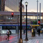 People walking in downtown Minneapolis as a Metro Transit bus moves down Nicollet Mall.